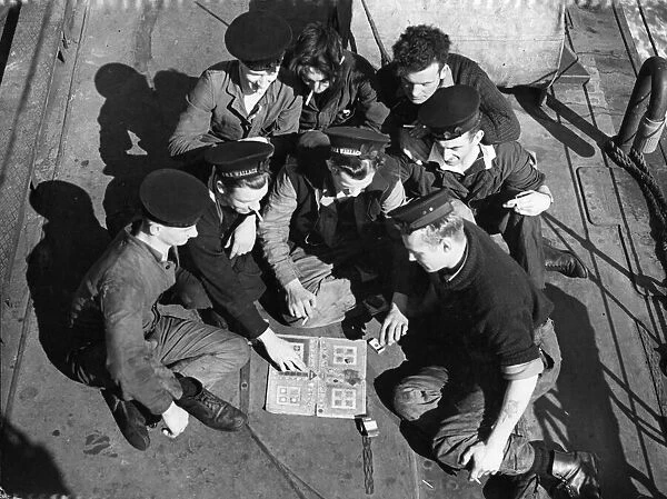 Navy crew play Ludo on board HMS Wallace. Picture taken circa 1st June 1942
