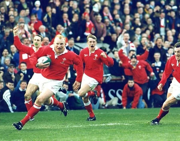 Neil Jenkins scores a try for Wales against Ireland cheered on by his team mates. 1998