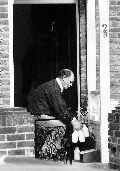 Neil Kinnock MP Former Labour Party Leader outside his house taking in his delivered milk