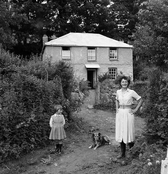 Nellie Whitworth, daughter Elaine, and Bob the dog, in front of Primrose Cottage