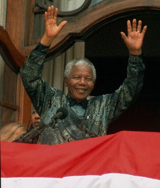 Nelson mandela waves to the crowd in Trafalgar Square during his visit to England