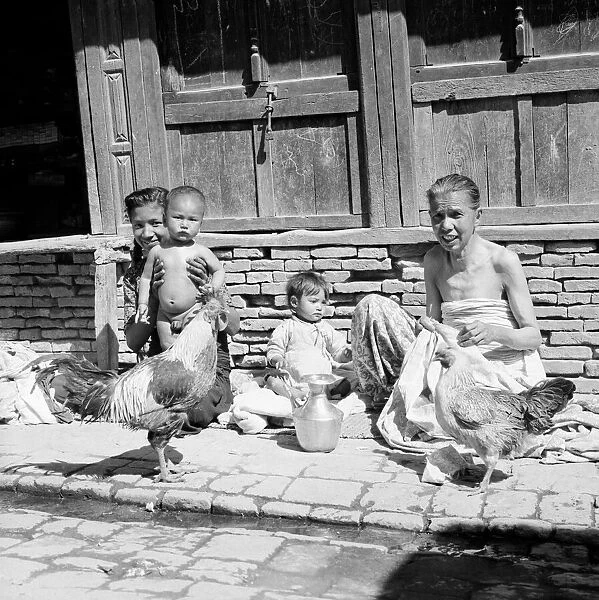Nepalese family seen here on the streets of Katmandu with their chickens