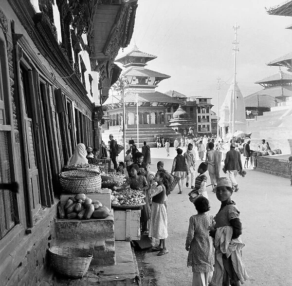 Nepalese market traders seen here in Durbar Square, Katmandu outside a Buddhist temple in