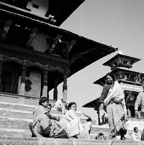 Nepalese women seen here resting on the steps of one of the temples Durbar Square