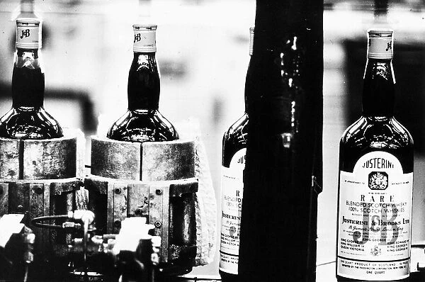 New bottles of whisky on the production line at a Whisky bottling plant 1971