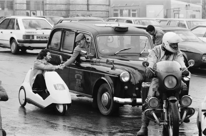 Framed Print : The New Electric Vehicle Picture shows a gentleman in London driving Framed Print : The New Electric Vehicle Picture shows a gentleman in London driving