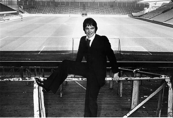 New Liverpool signing Alan Hansen poses at an empty Anfield stadium following his £