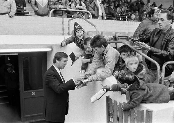 New Manchester United manager Alex Ferguson signs autographs for young Oxford United fans