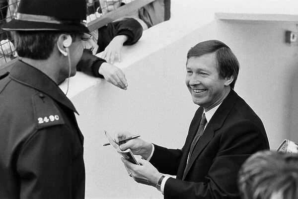 New Manchester United manager Alex Ferguson signs autographs for fans at the Manor Ground