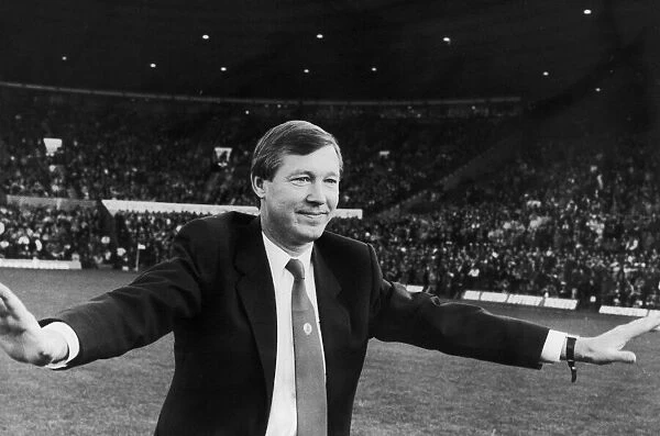 New Manchester United manager Alex Ferguson waves to the Old Trafford crowd before
