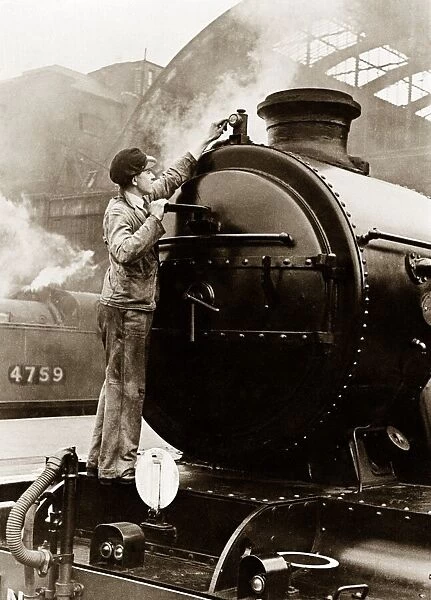 One of the new Merchant Navy Class Engines having its front lamp cleaned by the engine