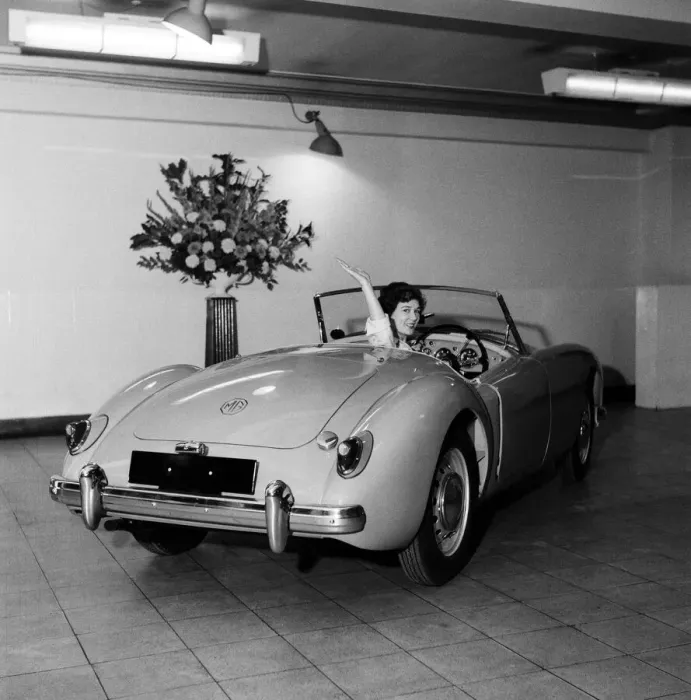 Framed Print : A new MG car on display in a showroom. 22nd September 1955
