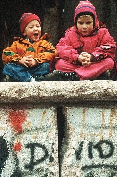 New Years Eve in Berlin Two children sitting on the Berlin Wall