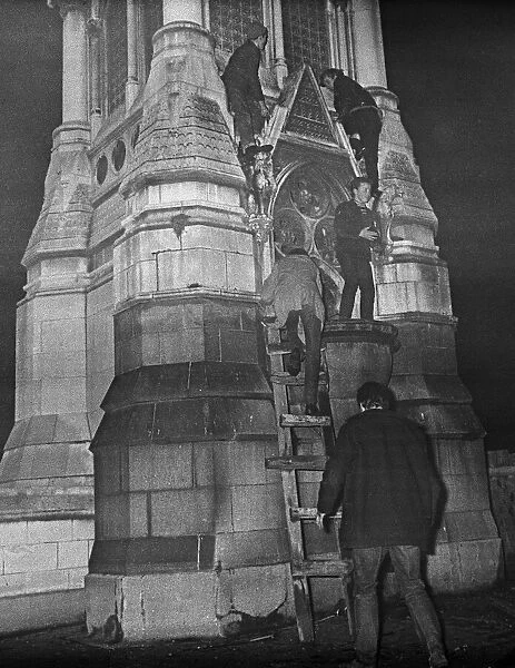 New Years reveller seen here climbing the Chamberlain Memorial in Chamberlain Square
