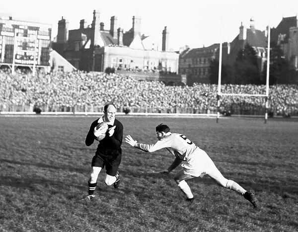 New Zealand full back Bob Scott attempts to to run the ball from the All Blacks 22 at