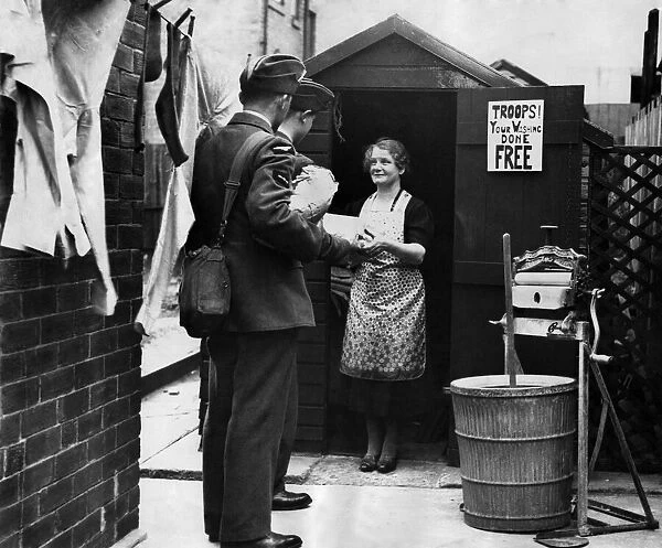 Newcastle housewife takes in laundry from the troops. June 1941 P012299