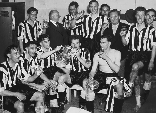 The Newcastle team in their dressing room at Wembley celebrate their one nil victory over