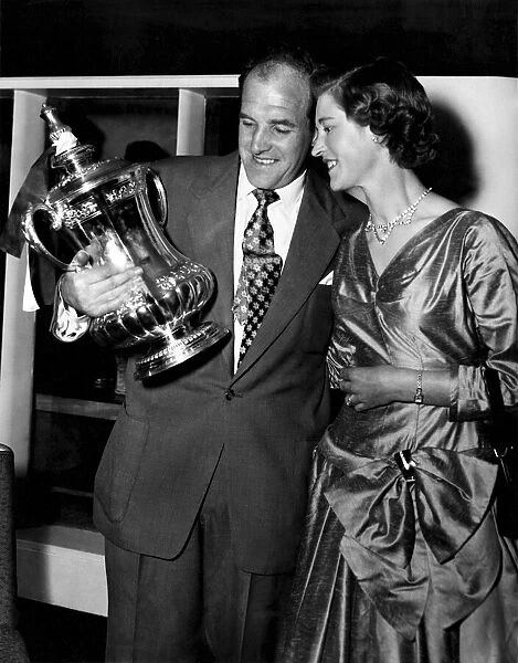 Newcastle United captain Jimmy Scoular shows off the FA Cup trophy to his wife after his
