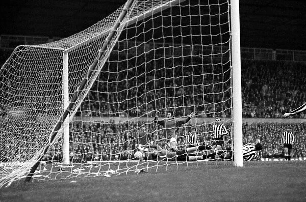 Newcastle United goalkeeper McFaul saves at the feet of Manchester United