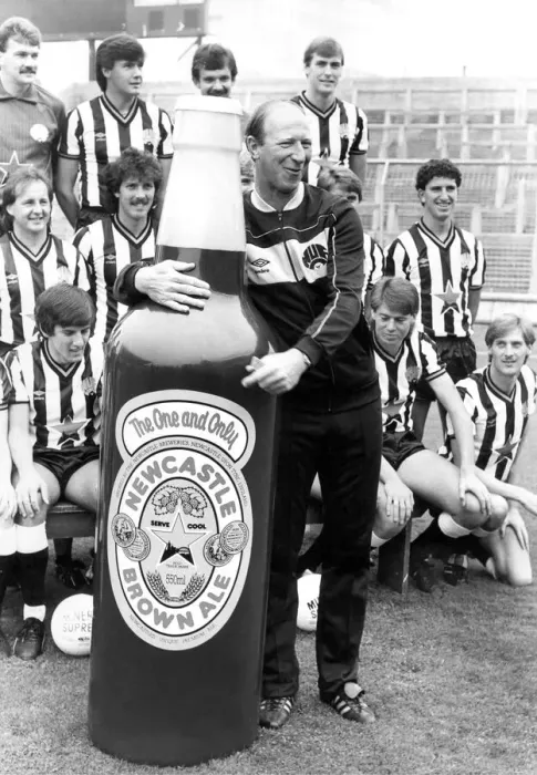 Framed Print : Newcastle United manager Jack Charlton clowning around with a giant Newcastle Brown Ale