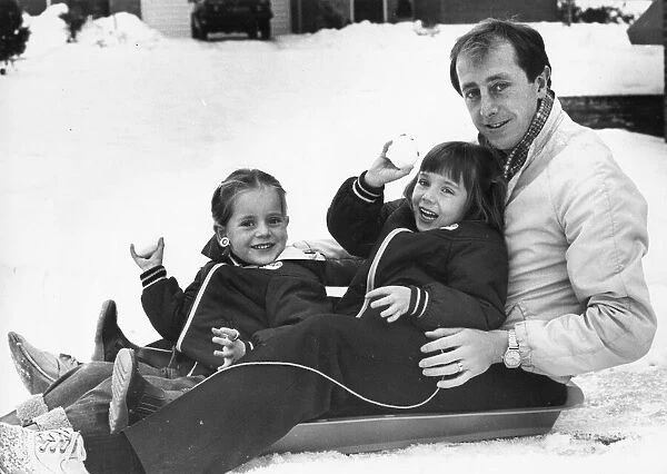 Newcastle United player Mick Martin enjoys a spot of sledging with his two daughters