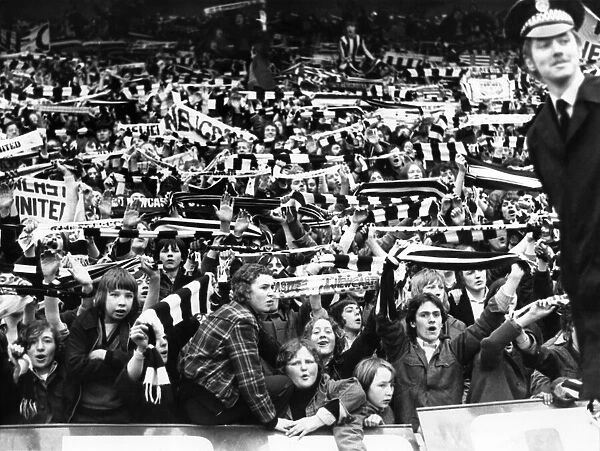 Newcastle United supporters wave their scarves at St James Park before the match