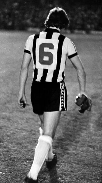 Newcastle United sweeper Irving Nattrass walks off the pitch carrying rocks