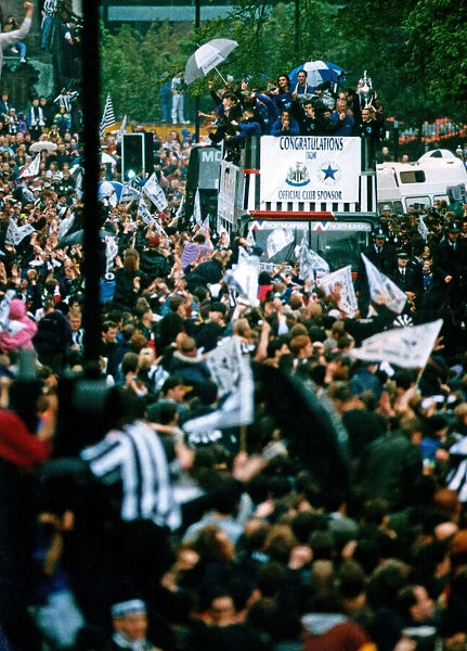 Newcastle United win the First Division. Players on the open top bus wave to fans during