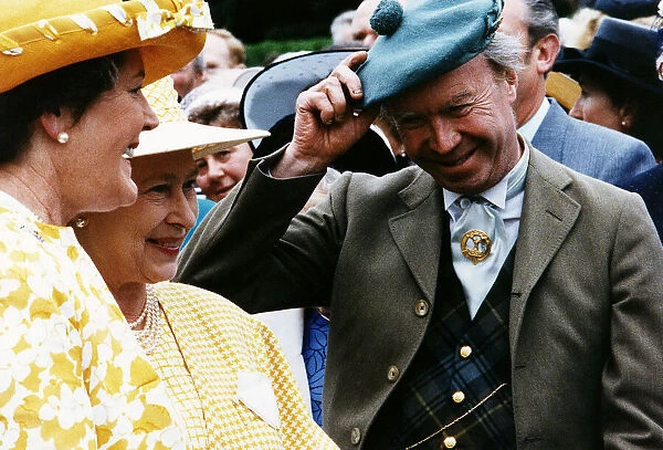 Nicholas Fairbairn MP conservative politician at garden party raising hat to the Queen
