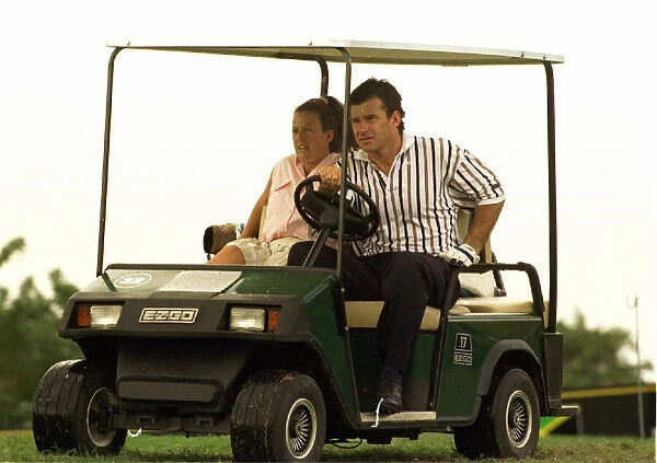 Nick Faldo gives his caddie Fanny a lift in a golf car in Jamaica