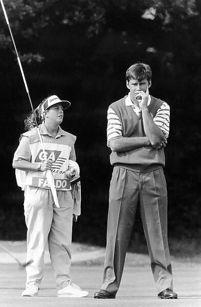 Nick Faldo Golf with caddy Fanny Sunesson holding the flag look on to the putting green