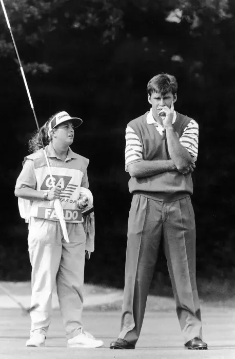 Framed Print : Nick Faldo Golf with caddy Fanny Sunesson holding the flag look on to the putting green Framed Print : Nick Faldo Golf with caddy Fanny Sunesson holding the flag look on to the putting green