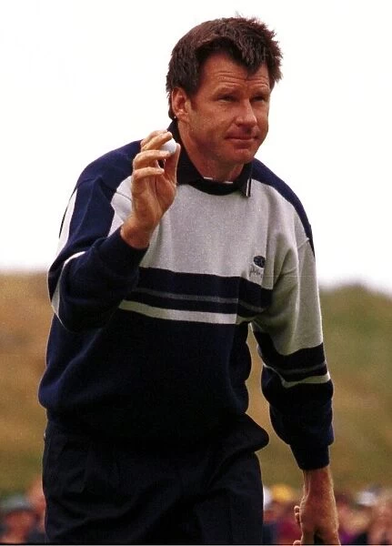 Nick Faldo manages a smile after putting the ball on the fourth hole during the third
