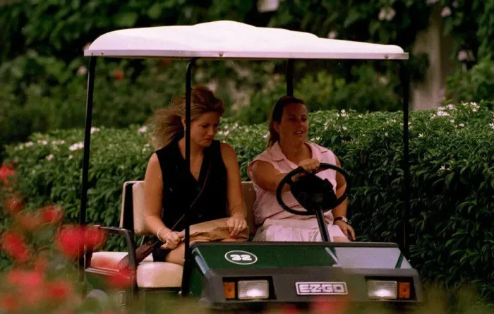 Framed Print : Nick Faldos new girlfriend Brenna gets a lift from his caddie Fanny