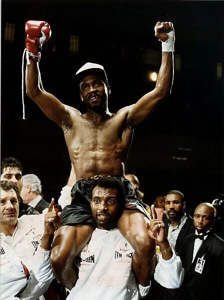 Nigel Benn Boxer Being lifted on the shoulders of Ambrose Mendy after beating Robbie
