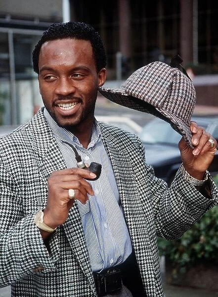 Nigel Benn intweed jacket holding hat and pipe March 1990