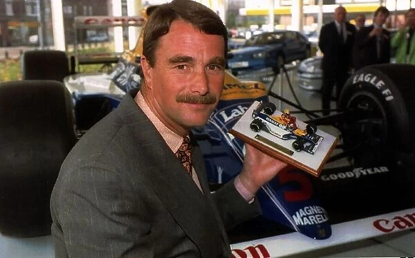Nigel Mansell Formula One racing driver with a model of himself