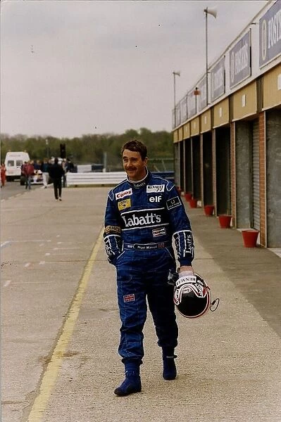 Nigel Mansell Motor Racing Grand Prix Formula One Driver walks down the pit road in his