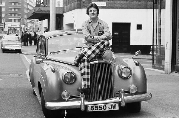Nineteen year old dart player Eric Bristow poses in London sitting on top of a Rolls