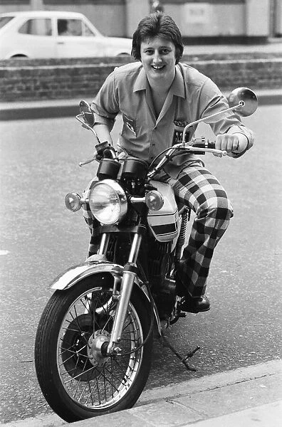 Nineteen year old dart player Eric Bristow poses in London sitting on a motorbike