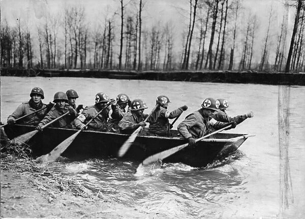 Some Ninth Army Medics man an assault boat to evacuate wounded across the swift