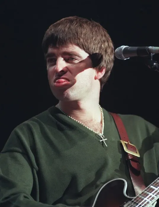 Framed Print : Noel Gallagher Oasis pop group December 1997 Sticking tongue out playing guitar Framed Print : Noel Gallagher Oasis pop group December 1997 Sticking tongue out playing guitar