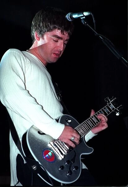 Noel Gallagher of the pop group Oasis playing guitar Sept 97