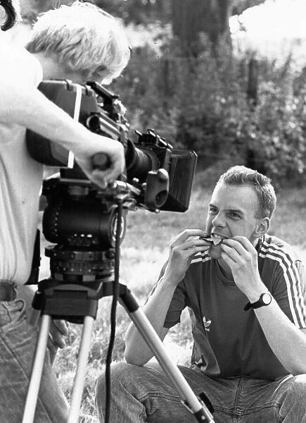 Norman Cook has a picnic lunch during filming of a Housemartins video at Park Farm