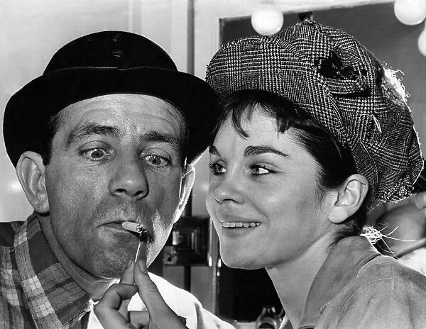 Norman Wisdom gets a light from co-star Sally Smith. August 1964 P009831