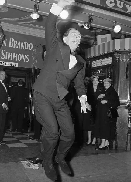 Norman Wisdom seen here waving to the crowds at the premiere of Guys