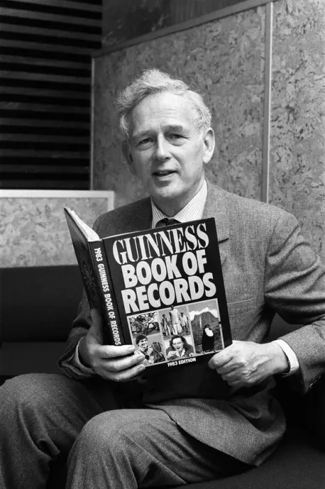 Framed Print : Norris McWhirter holding a copy of the Guinness Book of records Framed Print : Norris McWhirter holding a copy of the Guinness Book of records