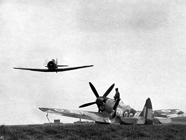 A North American Harvard dual control training aircraft passes over a Supermarine