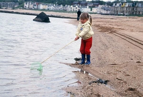 North Berwick beach 1987 girl fishing with net on stick