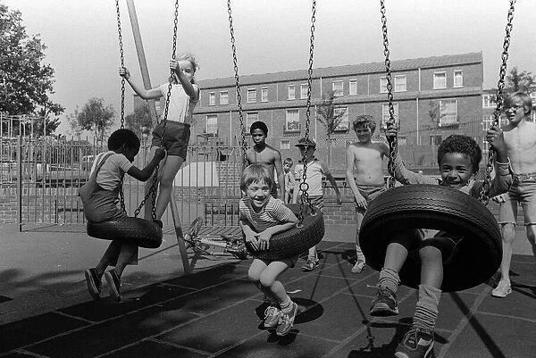 Notting Hill Carnival August 1981 Children playing on the swings in the recreation